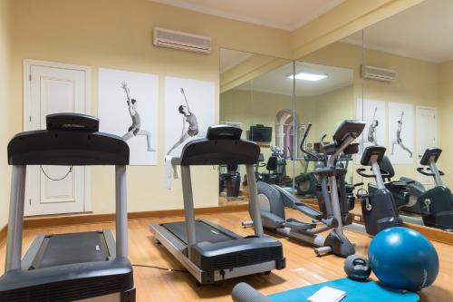 a gym with treadmills and elliptical machines at LP Los Portales Hotel Piura in Piura