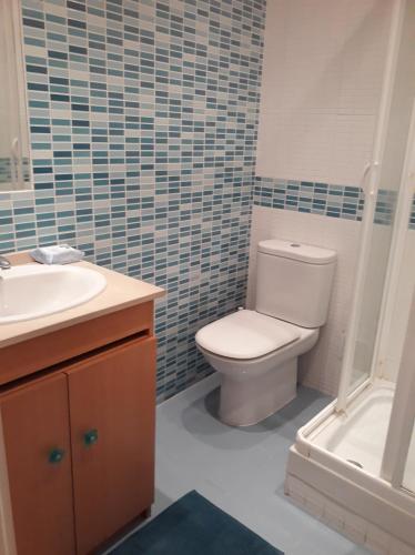 a bathroom with a toilet and a sink and a tub at Stay @Airport in Lisbon