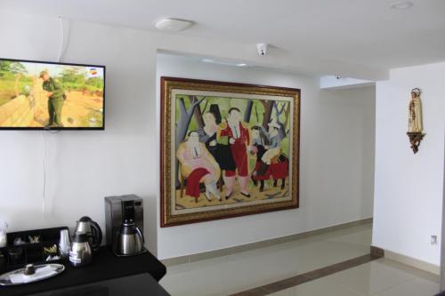 a painting hanging on a wall in a room at Hotel Pereira 421 in Pereira