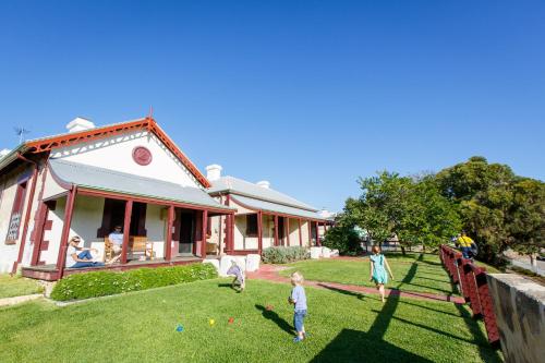 a group of people playing in the yard of a house at Fremantle Prison YHA in Fremantle