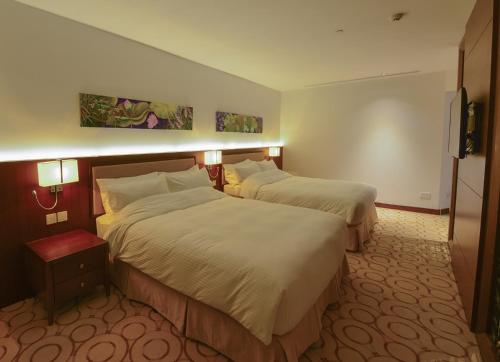 Ένα ή περισσότερα κρεβάτια σε δωμάτιο στο Aristo International Hotel