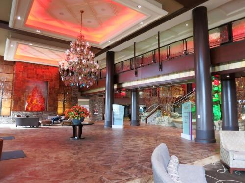 a large lobby with a chandelier in a building at Mount Airy Casino Resort - Adults Only 21 Plus in Mount Pocono
