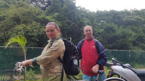 a man and a woman standing next to a motorcycle at Priyanna Guest, Forest view in Polonnaruwa