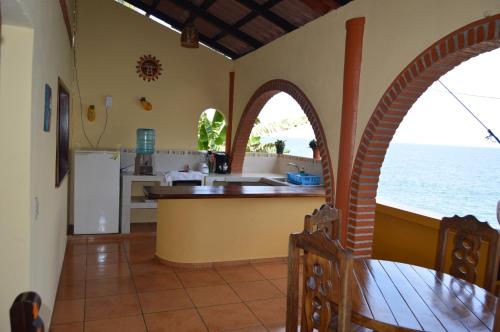 a kitchen with a view of the ocean at Casa Papaya in Yelapa