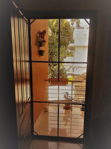 a view of a room with potted plants on a window at El Casa Homestay in Cochin
