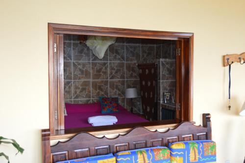 a bedroom with a bed with a mirror on the wall at Casa Frente al mar in Yelapa