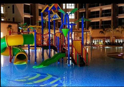 a playground in a building with a water park at Atlantis Residence Melaka in Melaka