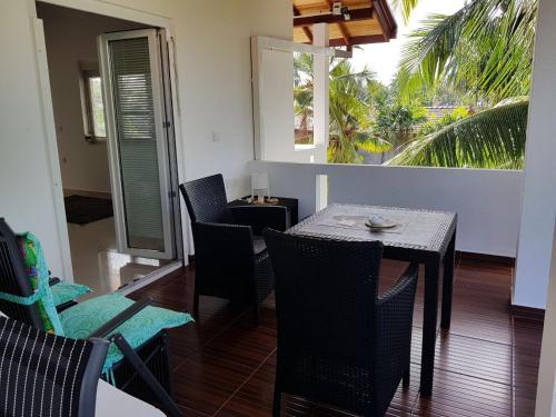 a dining room with a table and chairs on a balcony at Gästehaus Isabella in Beruwala
