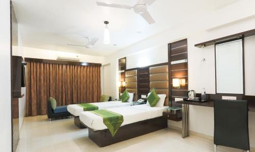 מיטה או מיטות בחדר ב-Hotel Apple Inn Vapi