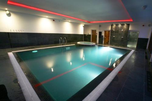 a large swimming pool in a hotel room at Park Hall Hotel and Spa Wolverhampton in Wolverhampton