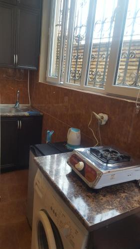 a kitchen with a stove top oven on a counter at Vazi in Tbilisi City