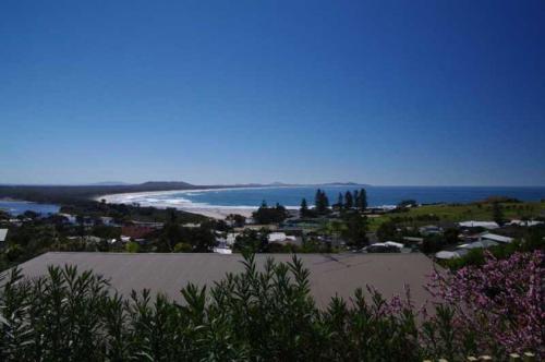 a view of a beach and the ocean from a hill at Beau Soleil, 28 East Street in Crescent Head