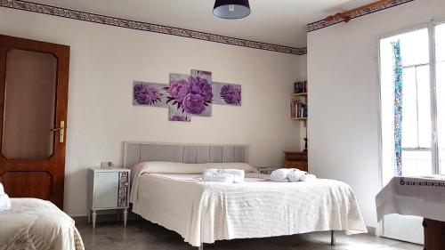 a bedroom with two beds with towels on a table at B&B Regina Elena in Pignola