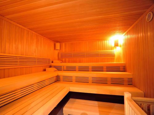 an empty sauna with wooden walls and wooden floors at DORMERO Hotel Altes Kaufhaus Lüneburg in Lüneburg