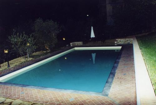 a swimming pool in a yard at night at villa oliveta in San Gimignano