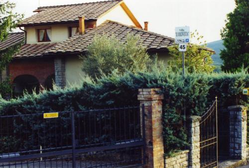 a house with a fence and a sign that says mph at villa oliveta in San Gimignano