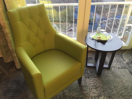 a yellow chair sitting next to a table at Landhotel Witte-König in Garrel