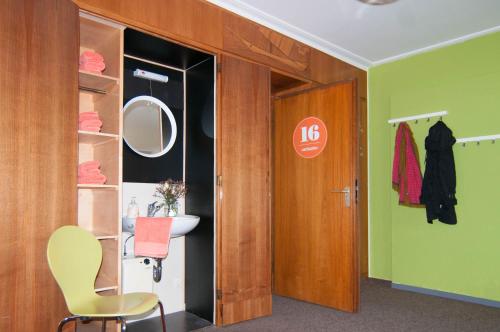 a bathroom with a sink and a mirror at Inselhostel in Lindau