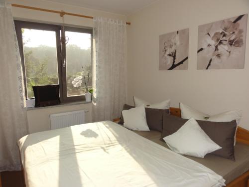 a bedroom with a bed and a window at Villa am Weinberg Waren Müritz in Waren