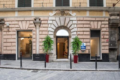 an entrance to a building with two potted plants at Best Western Porto Antico in Genova