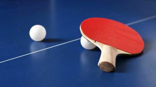 a red tennis racket and two balls on a table at Hotel Prestige in Rimini