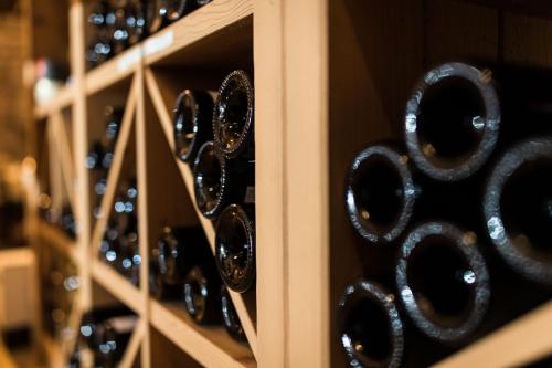 a row of wine bottles in a wine cellar at Hotel Patriarch in Tirolo