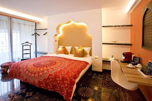 a hotel room with a bed and a desk at PLAZA INN stays design Dortmund in Dortmund