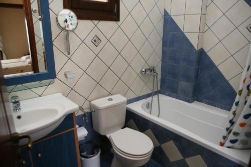 a bathroom with a toilet and a sink and a tub at Katsios Studios in Parga