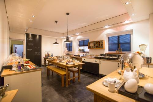 a large kitchen with tables and counters in a room at Hotel Bürkle in Fellbach