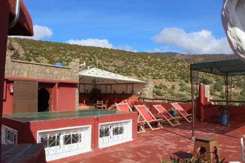 a group of chairs sitting on top of a roof at Tigmi Dar Samy in Bine el Ouidane