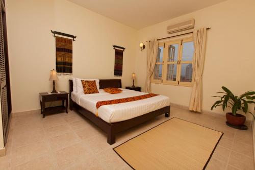 a bedroom with a bed and a plant in it at Grand Residence in Phnom Penh