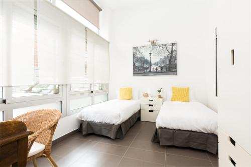 Postel nebo postele na pokoji v ubytování Apartamentos Cornellalux