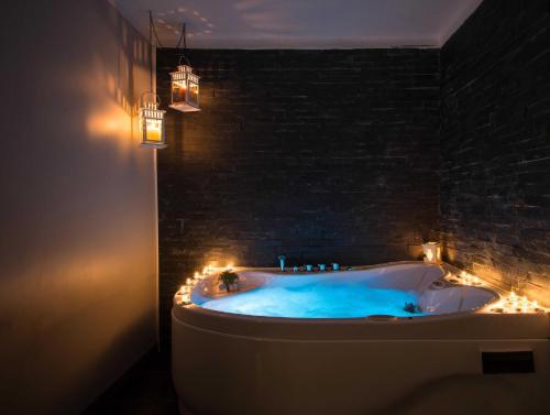a bathroom with a tub with lights in it at Casa Alfazema do Monte in Santa Marta