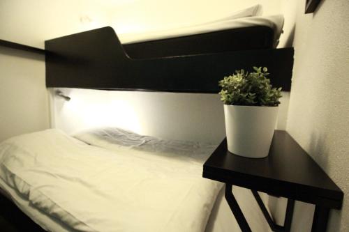 a bedroom with a bed and a table with a plant at Hotell Centralstation in Uppsala