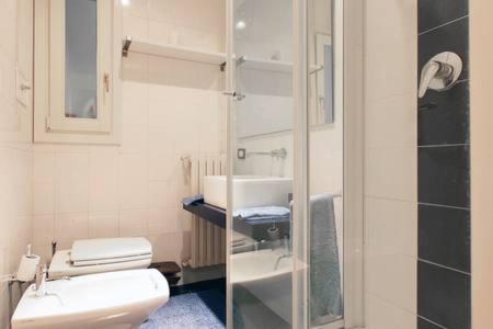 a bathroom with a toilet and a sink and a shower at Appartamento centro storico corso magenta cadorna in Milan