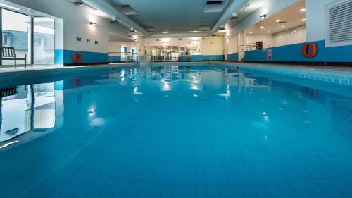 a large swimming pool with blue water at The Inn at Dromoland in Newmarket on Fergus