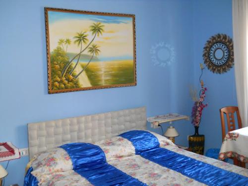 カリアリにあるAl Relaxのベッドルーム1室(ベッド1台付)が備わります。壁には絵画が飾られています。