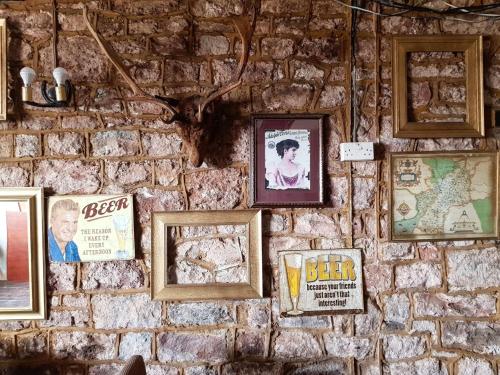 a brick wall with pictures on it at Littledean House Hotel in Cinderford