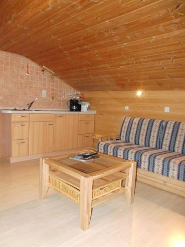 a living room with a couch and a coffee table at Haus Christoph in Bad Wiessee