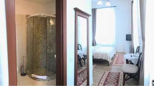 two views of a bathroom with a shower and a bedroom at Pensiunea Gasthaus Alte Post in Sighişoara