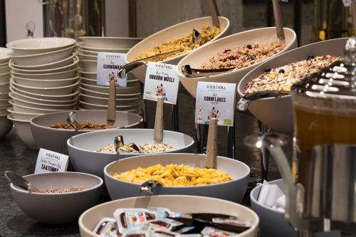 a bunch of bowls of food on a table at Hotel Huber Hochland in Maurach