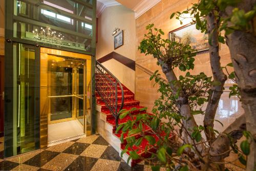 a staircase in a building with a red stair case at Hotel Europa in Poprad