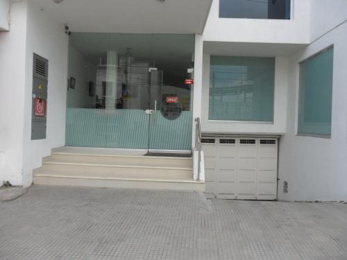 a store front with a glass door and stairs at Hotel Ginebra Sincelejo in Sincelejo