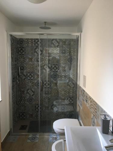 a bathroom with a shower with a toilet and a sink at Appartamentino Vittorio Emanuele in Bari