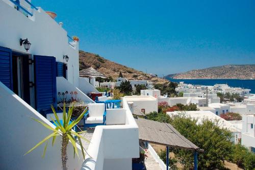 a view of a town with white buildings and the ocean at Pension The Big Blue in Katapola