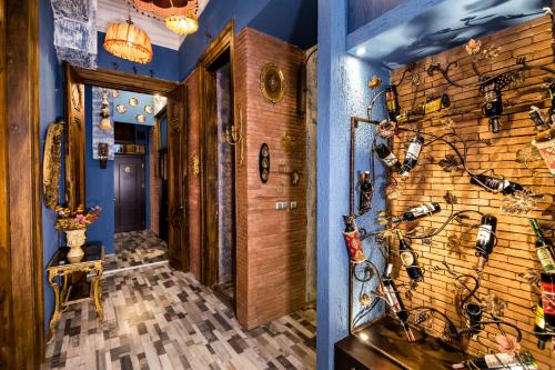 a hallway with a wall filled with lots of glasses at Tiflis Inn Boutique Hotel in Tbilisi City