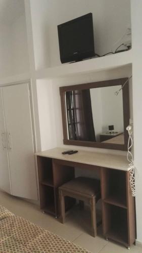 a desk with a tv on top of a mirror at Mediterranean Blue in Kavos