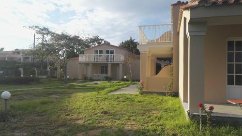 a view of a house with a yard at Mediterranean Blue in Kavos