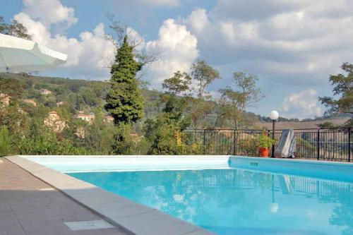 a blue swimming pool with a mountain in the background at Agriturismo Le Capanne in San Dalmazio