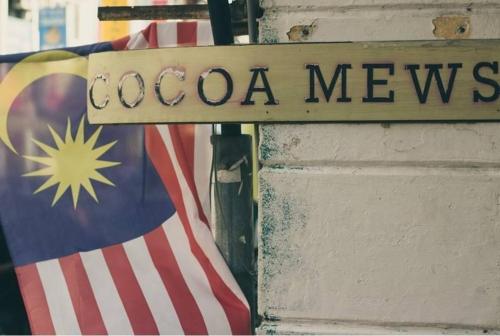 a sign that reads cocoa mexico next to a flag at Cocoa Mews Cafe and Homestay in George Town